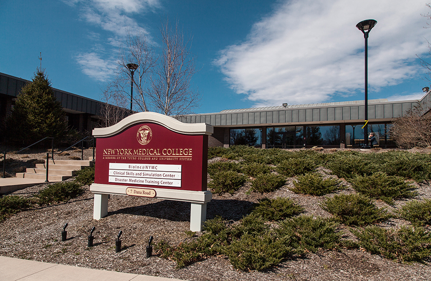 Front of 7 Dana Road building with NYMC building sign looking from the right.